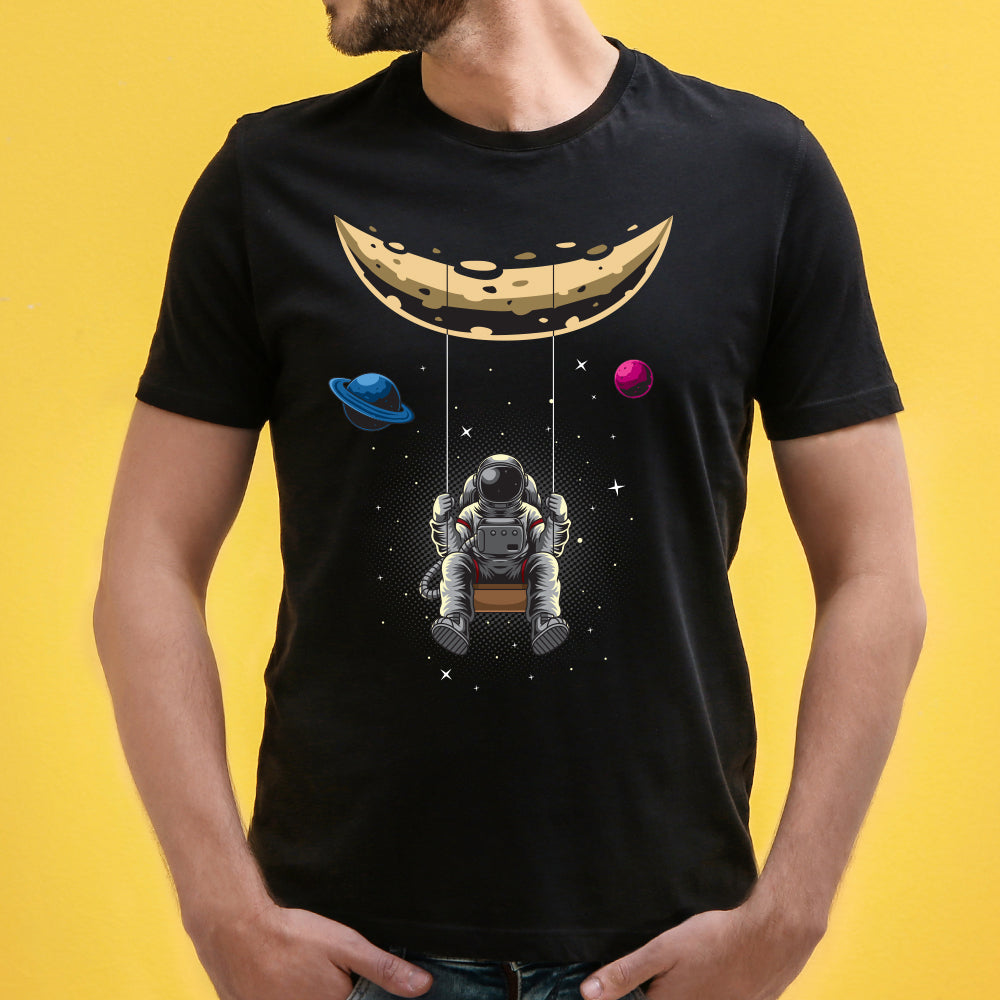 Shop the 'Moon Astronaut' Unisex Graphic T-Shirt by WhimsyWrap, featuring a captivating cartoon astronaut design on the moon. This space-themed T-shirt is perfect for casual wear, adding an adventurous and out-of-this-world vibe to your wardrobe. Ideal for both men and women who love space exploration and unique graphic tees.